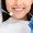 Perfect smile. Close up of smiling young woman attenting dental clinic, hands of dentist with tools, cropped